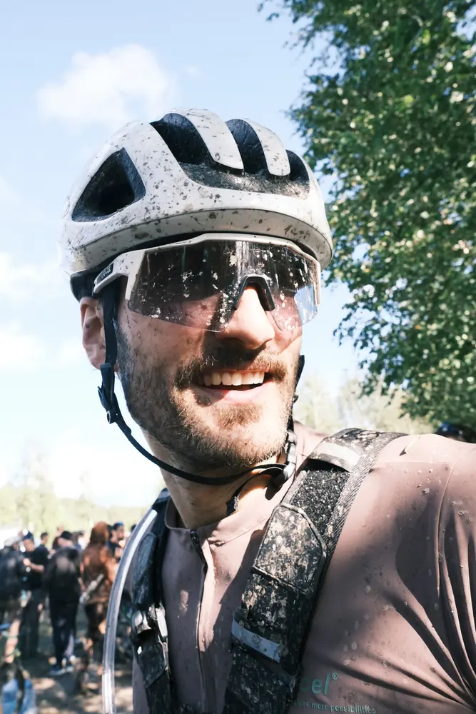 A member of FURY ROAD in a helmet and glasses on the background of a summer forest