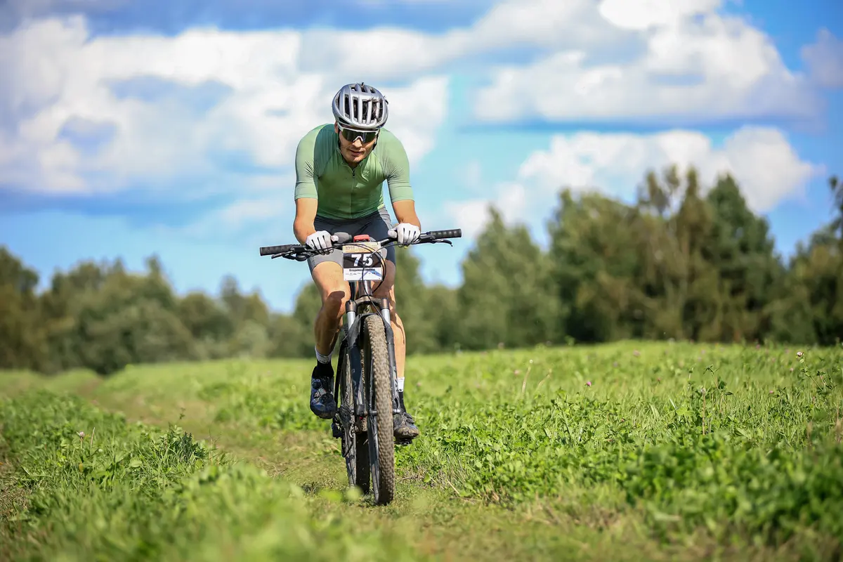MTB-Koskijarvi racer on a forest trail among tall grass