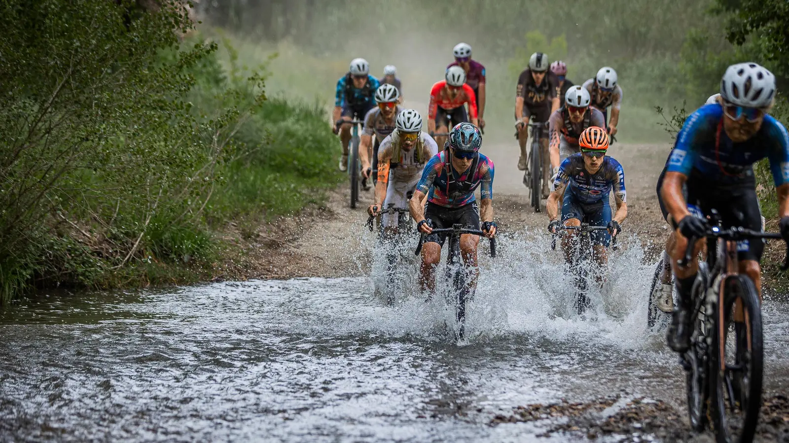 The Traka members cross the ford on gravel bikes