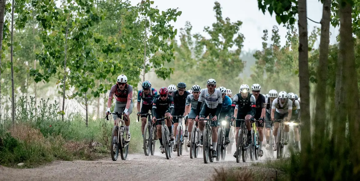Group of participants The Traka on a dirt road among the trees